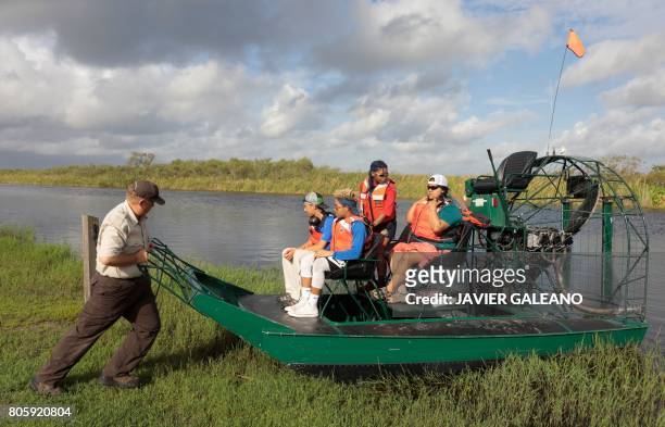 Rolf Olson, U.S. Fish & Wildlife Service officer, pushes an airboat before an airboat tour with a Soul River youth group at the Arthur R. Marshall...