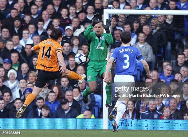 Hull City's Richard Garcia has a shot on goal blocked by Everton goal keeper Tim Howard .