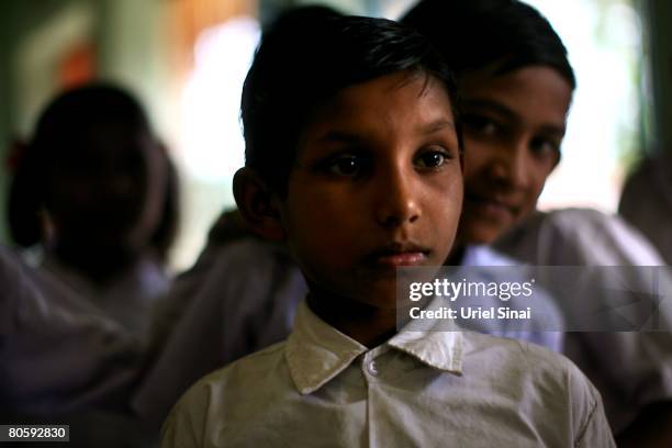 Surat Shende, the son of Anil Shende who committed suicide, stands in the local school on April 2008 in the village of Bhad Umri in the Vidarbha...