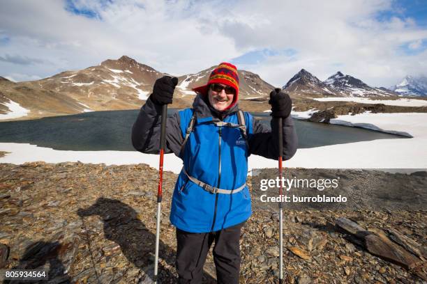 a seasoned hiker stands before the lake ernest shackleton would have crossed before descending into stromness - antarctica people stock pictures, royalty-free photos & images