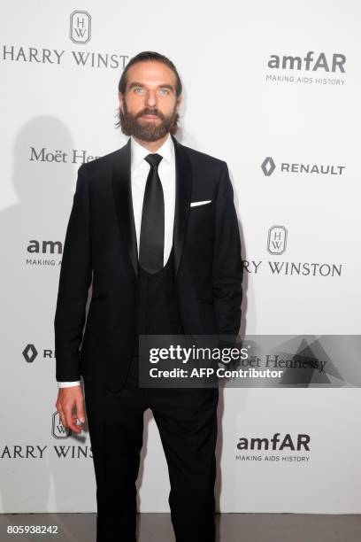Hairstylist John Nollet poses during a photocall, as part of a dinner organized by the foundation for AIDS research amfAR on July 2, 2017 at the...