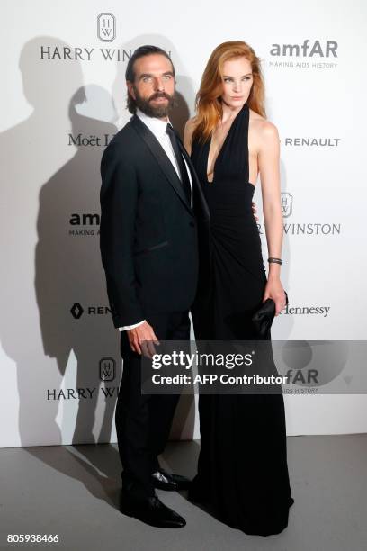 Model Alexina Graham and hairstylist John Nollet poses during a photocall, as part of a dinner organized by the foundation for AIDS research amfAR on...