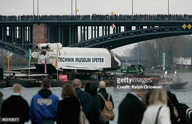 Thousands of spectators watch the Russian space shuttle 'Buran' passing the Theodor-Heuss Bridge at the river Rhineon April 10, 2008 in Mainz,...