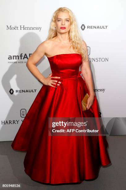 Greek film director Angela Ismailos poses during a photocall as she arrives for a dinner organised by the foundation for Aids research amfAR, on July...