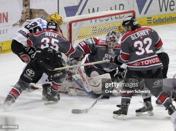 Andreas Renz of Cologne and John Slaney defend the goal of goalkeeper ...