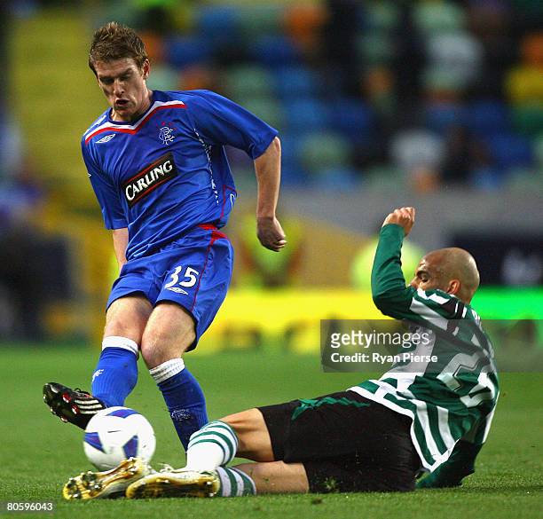 Gladstone of Sporting Lisbon tackles Steven Davis of Rangers during the UEFA Cup Quarter Final second leg match between Sporting Lisbon and Rangers...