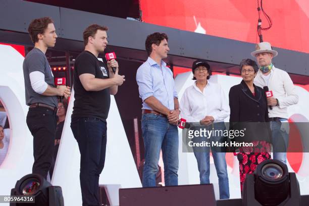 Craig Kielburger and Marc Kielburger deliver remarks at We Day Canada as Prime Minister Justin Trudeau, Daisy Wenjack, Pearl Wenjack and Gord Downie...