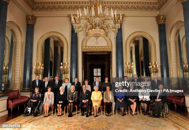 Britain's Queen Elizabeth II and the Duke of Edinburgh pose with Civil Service Commissioners before a reception at Buckingham Palace, London. They...