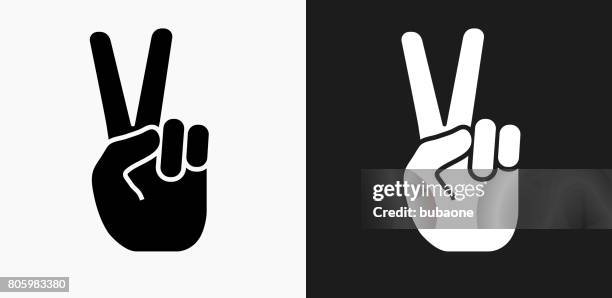 peace sign icon on black and white vector backgrounds - victory sign stock illustrations