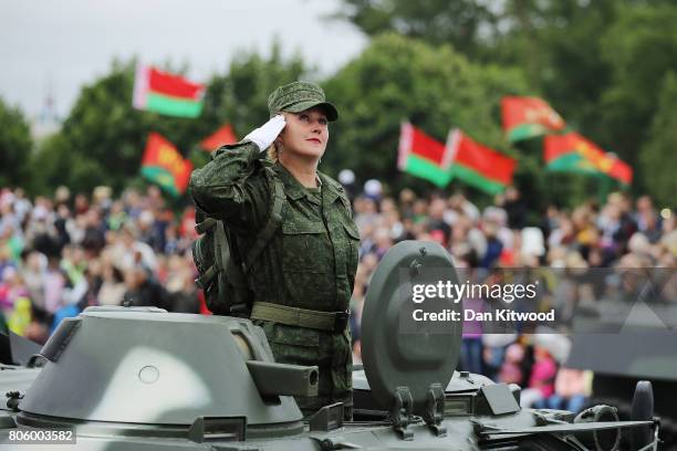 Female soldier salutes as tanks roll past Belarusian President Alexander Lukashenko during the Independence Day Parade on July 3, 2017 in Minsk,...