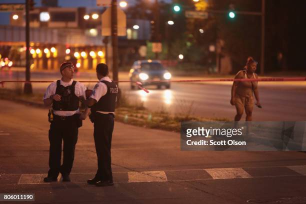 Police secure the crime scene as they search for evidence after three people were shot in the Lawndale neighborhood on July 2, 2017 in Chicago,...