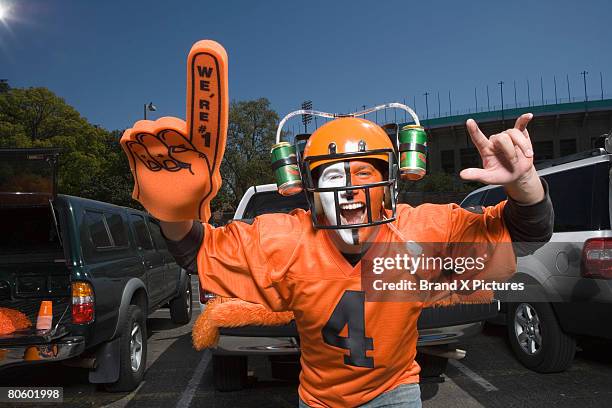 painted fan with beer helmet - tailgate stock-fotos und bilder