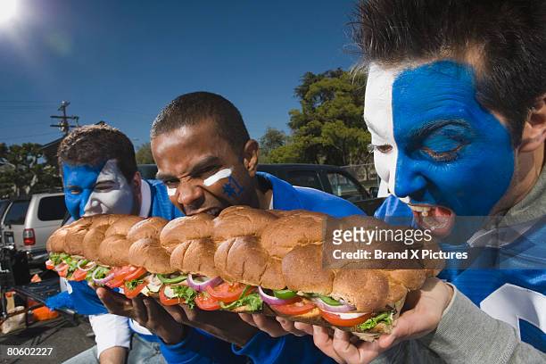 hungry fans with sandwich - grinder sandwich fotografías e imágenes de stock