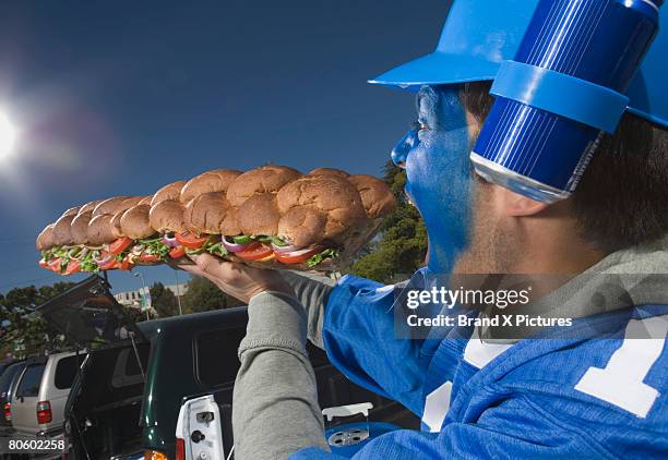 hungry fan with sandwich and beer - grinder sandwich fotografías e imágenes de stock