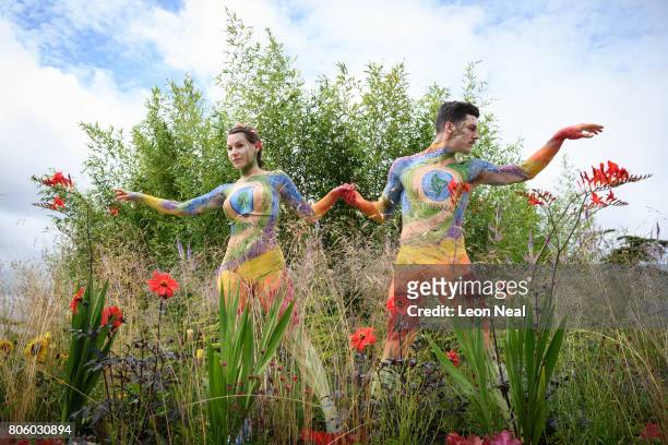 Models wearing floral bodypaint pose for photographs on the "Perennial Sanctuary Garden" exhibit on the press preview day of the Hampton Court Palace...