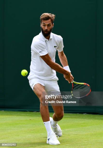 Benoit Paire of France plays a backhand during the Gentlemen's Singles first round match against Rogerio Dutra Silva of Brazil on day one of the...