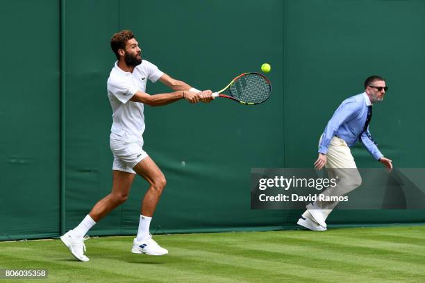 Benoit Paire of France plays a forehand during the Gentlemen's Singles first round match against Rogerio Dutra Silva of Brazil on day one of the...