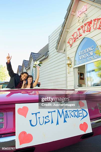 couple at drive up wedding chapel - las vegas wedding stock pictures, royalty-free photos & images
