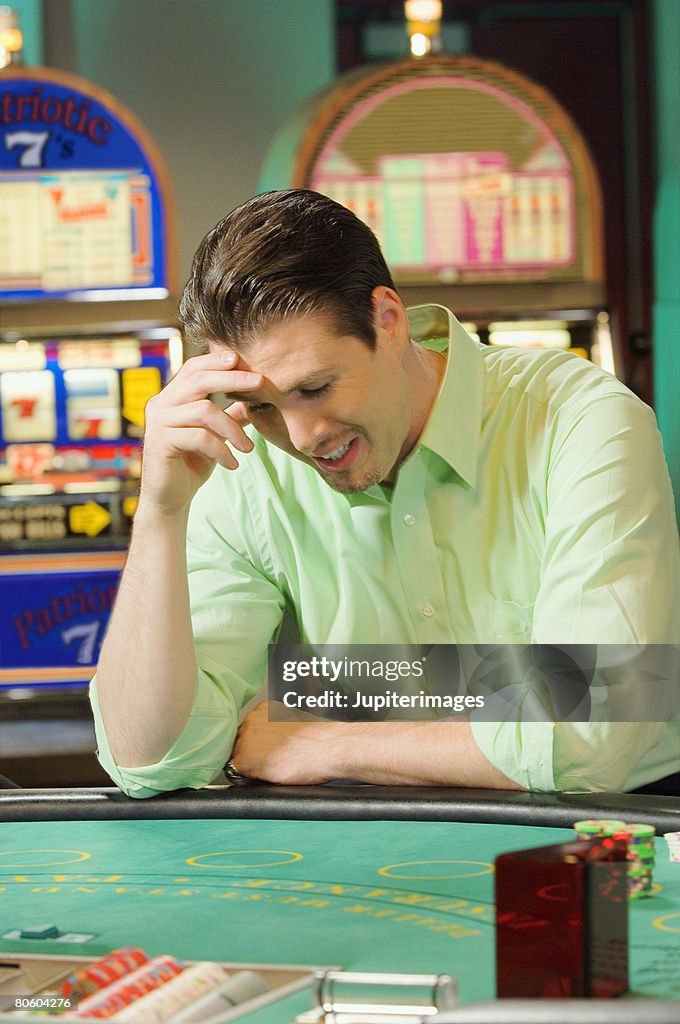 Man losing at gambling table