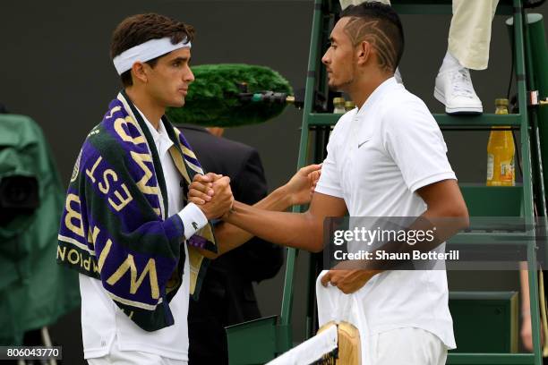 An injured Nick Kyrgios of Australia shakes hands with Pierre-Hugues Herbert of France as he retires during the Gentlemen's Singles first round match...