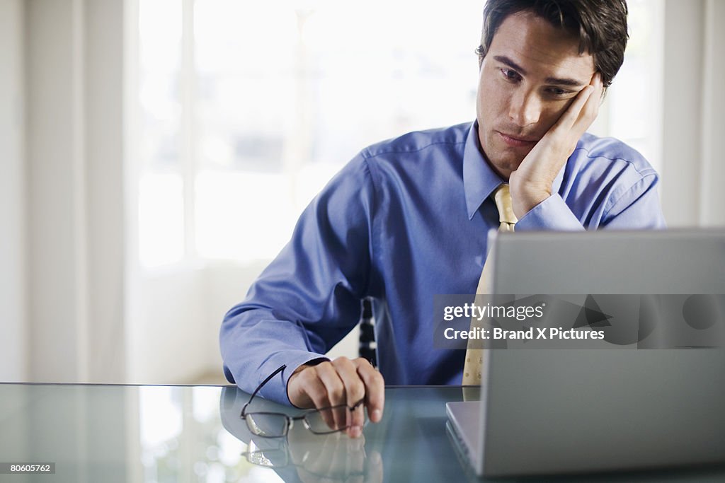 Frustrated businessman with laptop computer