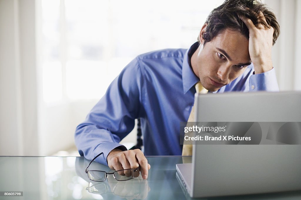 Frustrated businessman with laptop computer