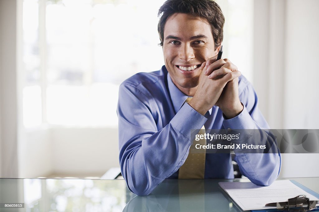 Smiling businessman at desk