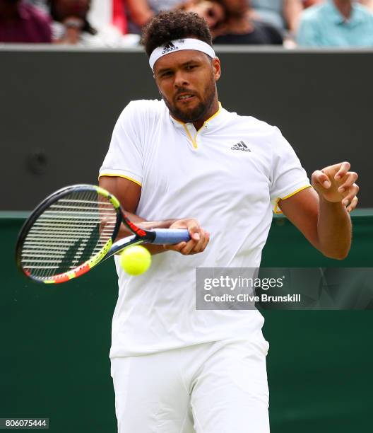 Jo-Wilfried Tsonga of France plays a forehand during the Gentlemen's Singles first round match against Cameron Norrie of Great Britain on day one of...