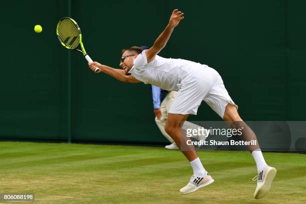 Jerzy Janowicz of Poland stretches to play a forehand during the Gentlemen's Singles first round match against Denis Shapovalov of Canada on day one...