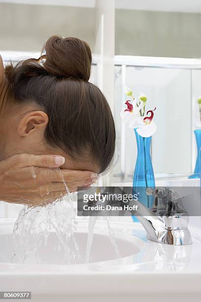 woman washing face - dana workman stockfoto's en -beelden