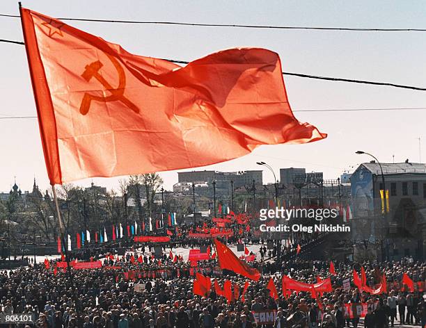 Communist supporters with red flags and banners march along a bridge near the Kremlin May 1, 2001 in downtown Moscow, Russia during May Day...