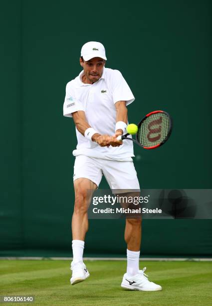 Roberto Bautista Agut of Spain plays a backhand during the Gentlemen's Singles first round match against Andreas Haider-Maurer of Austria on day one...