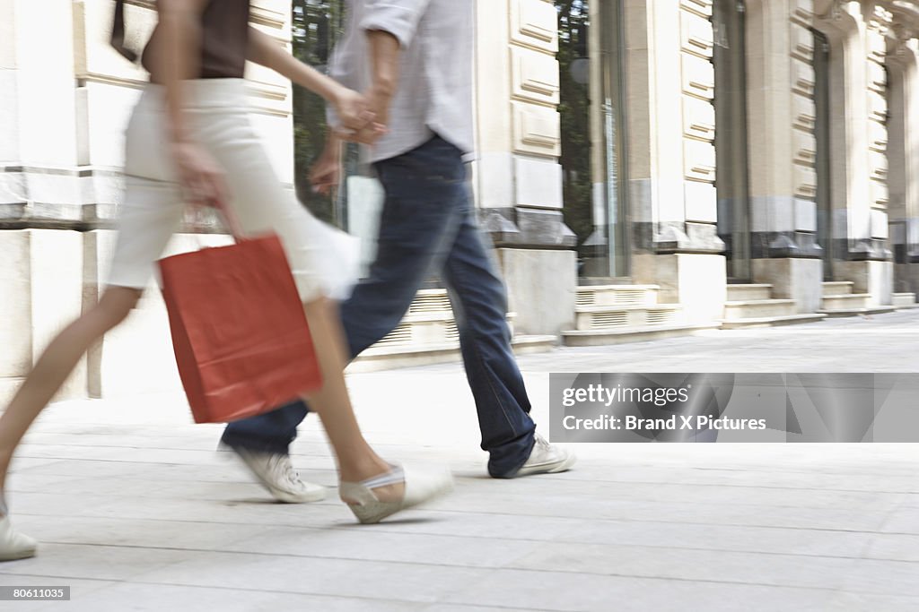 Cropped couple with shopping bags