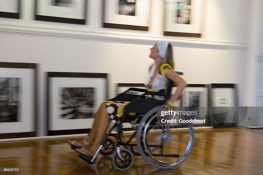 Woman in wheelchair in gallery