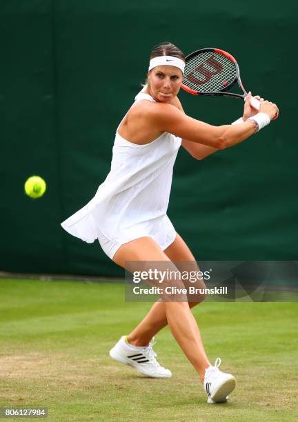 Mandy Minella of Luxembourg plays a backhand during the Ladies Singles first round match against Francesca Schiavone of Italy on day one of the...