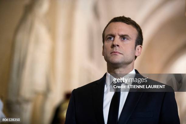 French President Emmanuel Macron walks through the Galerie des Bustes to access the Versailles Palace's hemicycle for a special congress gathering...