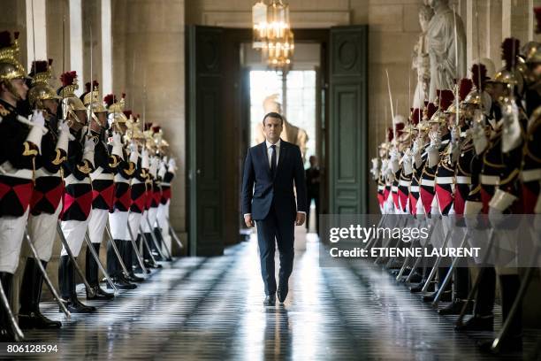 French President Emmanuel Macron walks through the Galerie des Bustes to access the Versailles Palace's hemicycle for a special congress gathering...