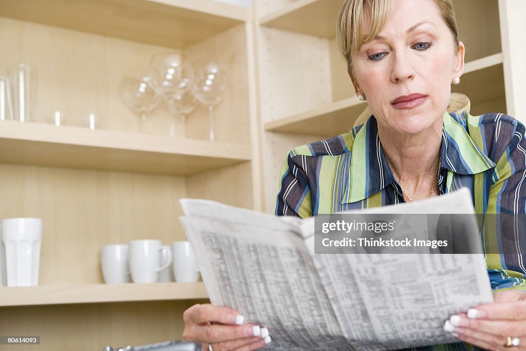 Woman reading newspaper