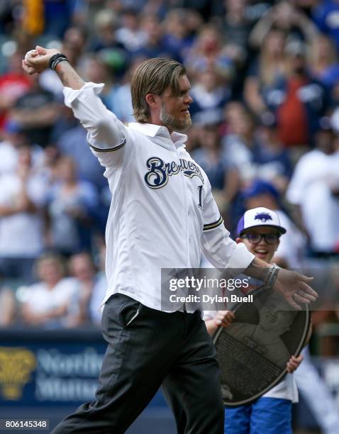 Former Milwaukee Brewers Corey Hart throws the ceremonial first pitch before the game against the Miami Marlins at Miller Park on June 30, 2017 in...