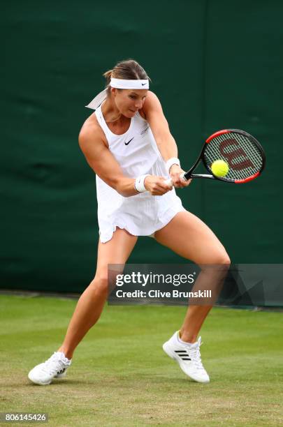 Mandy Minella of Luxembourg plays a backhand during the Ladies Singles first round match against Francesca Schiavone of Italy on day one of the...