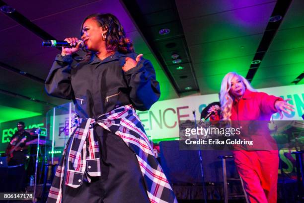 Kandi Burruss and Tameka 'Tiny' Harris of Xscape perform onstage at the 2017 ESSENCE Festival Presented By Coca Cola at the Mercedes-Benz Superdome...
