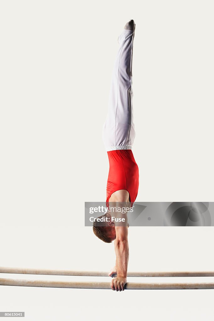Gymnast Doing Handstand on Parallel Bars
