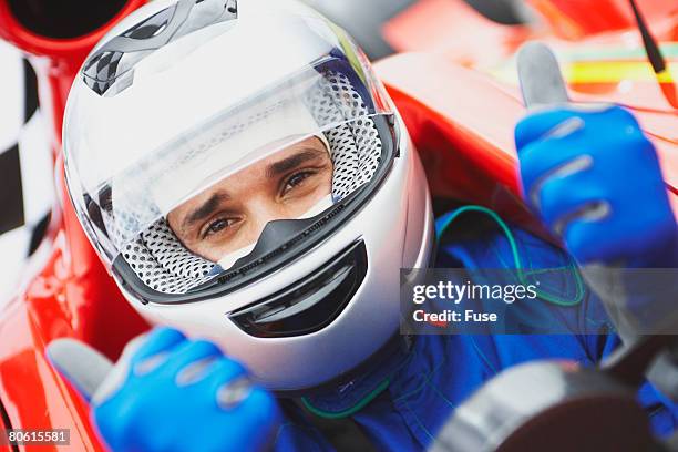 racecar driver giving thumbs up - car racing helmet stock pictures, royalty-free photos & images