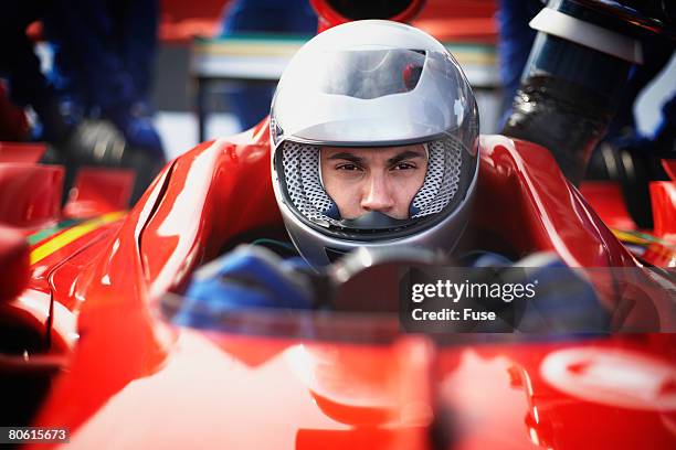 racecar driver preparing for a race - race car driver portrait stock pictures, royalty-free photos & images