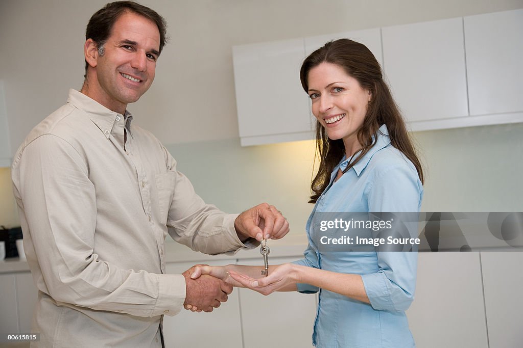 Estate agent giving a woman a key