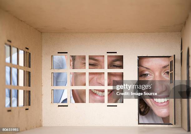 a couple looking inside a dolls house - dollhouse 個照片及圖片檔