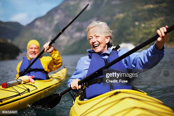 senior couple kayaking together - older person kayaking stock pictures, royalty-free photos & images