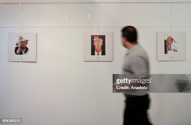 Visitor views the cartoons of United States President Donald J. Trump at International Trumpism Cartoon and Caricature Exhibition in Tehran on July...