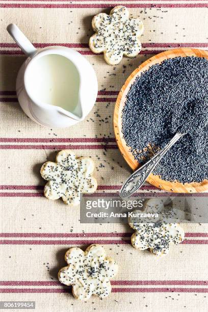 flower shaped cookies with poppy seeds and white chocolate, top view - poppy seed stock pictures, royalty-free photos & images