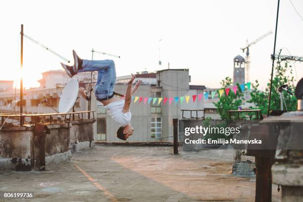 free running parkour athlete on the rooftop - backflipping imagens e fotografias de stock